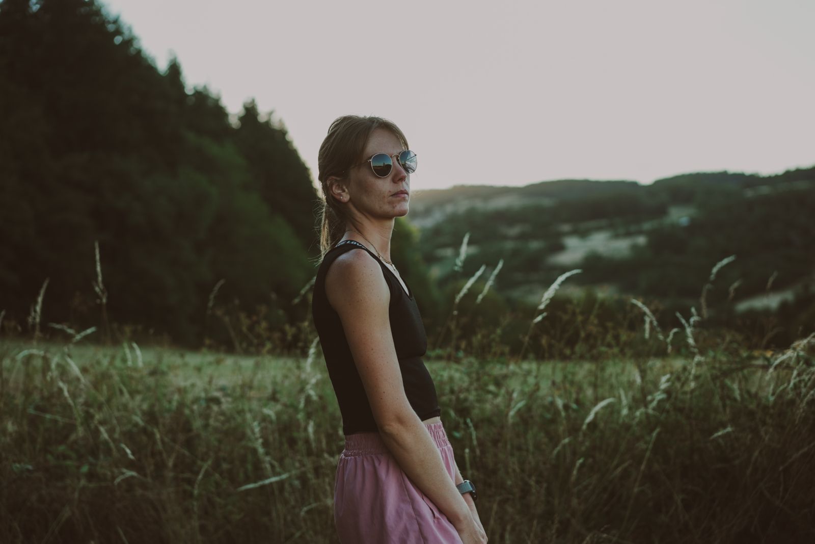 Coureuse posant dans les herbes du Forez au coucher du soleil